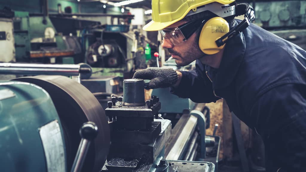 Manufacturing - man looks at machine