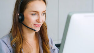 -Business people wearing headset working in office to support remote customer or colleague. Call center, telemarketing, customer support agent provide service on telephone video conference call.Call answering company